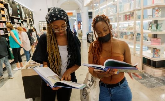High school students browsing books in London bookshop