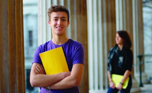 student abroad with yellow folder