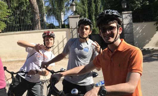 students biking abroad in alicante spain sunny day