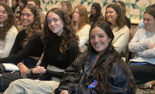 Students sitting in a room waiting for orientation to begin