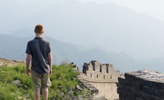 Study abroad student looking out on the Great Wall of China