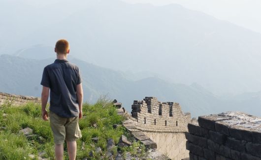 Study abroad student looking out on the Great Wall of China