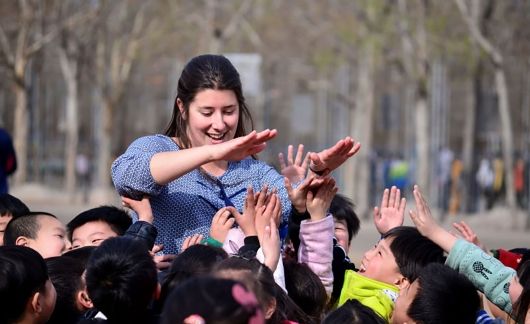 Teacher high-fiving her students