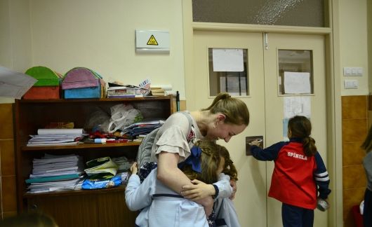 Teacher hugging student