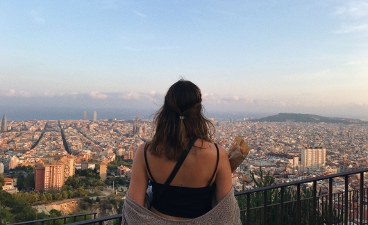 student looking over city barcelona famous