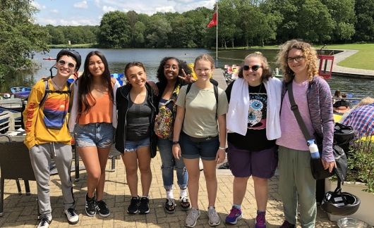 High school students posing by the water in Amsterdam