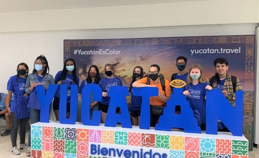 High school students posing with Yucatan sign in Mexico