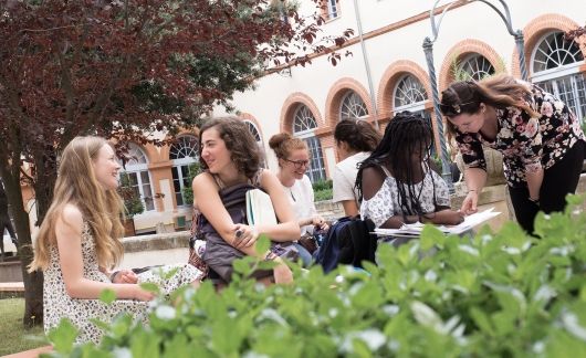 High school students conversing in garden at CIEE Center in Toulouse