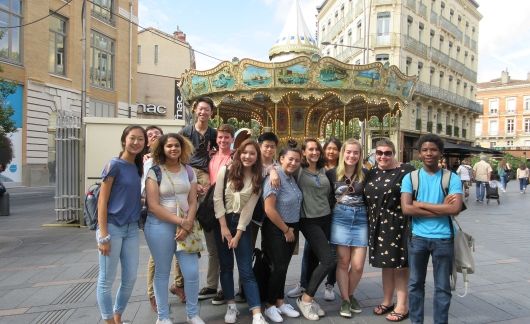 High school students in front of a carousel in Toulouse