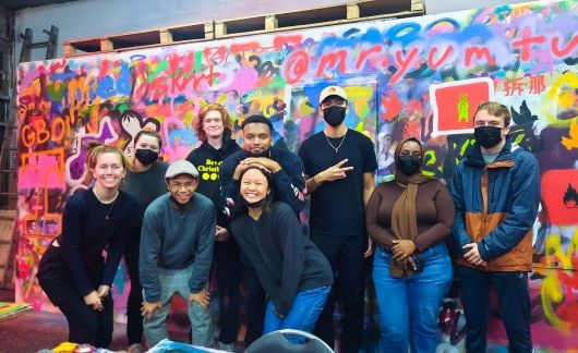 London students by graffiti wall