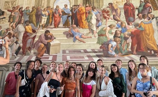 rome group in front of mural