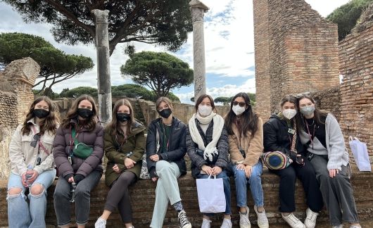 Rome students sitting at ruins