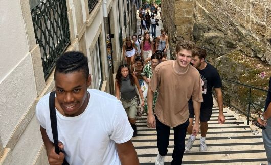 students walk city steps in portugal