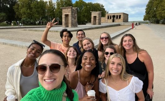 Teachers posing for group selfie at temple site in Madrid