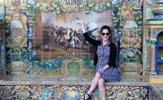 Teach in Spain participant sitting on art bench in Madrid