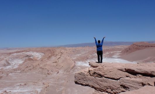 santiago ch student in desert posing with arms up