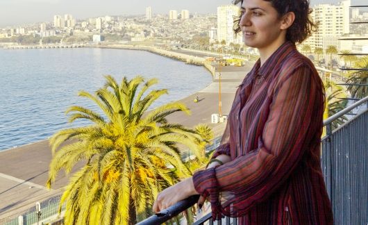 santiago ch student intern on balcony overlooking water