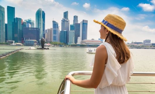 singapore girl on boat looking at buildings