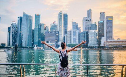 singapore girl on boat overlooking harbor and city