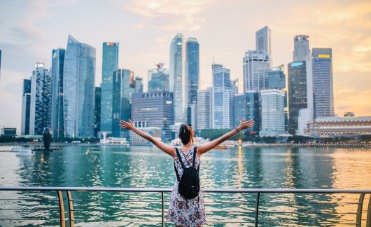 singapore girl on boat overlooking harbor and city