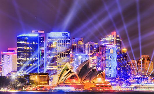 sydney opera house at night with spotlights