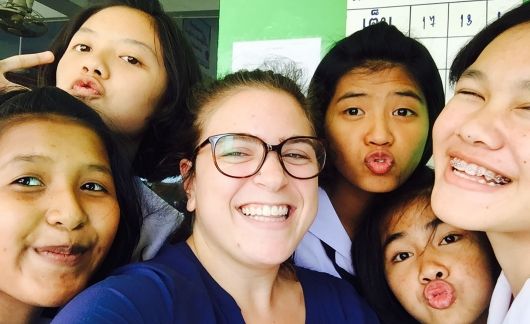 Teacher and students smiling in group photo