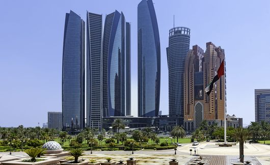 abu dhabi skyline buildings flag