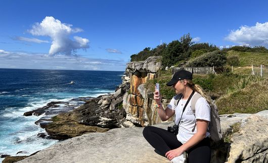 sydney_student-taking-photo-by-the-water-on-a-lookout-at-south-head-heritage-trail.JPG