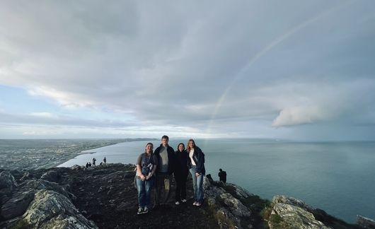 Participants-overlook-ocean-rainbow