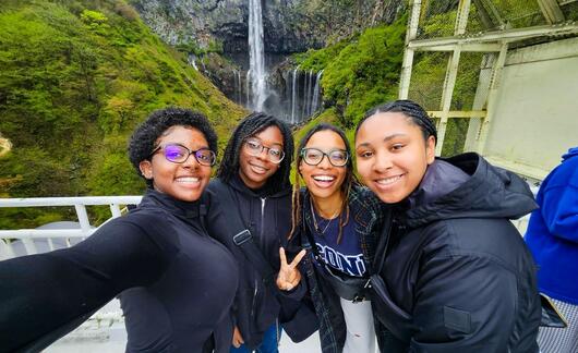 tokyo-hssa-four-female-students-posing-waterfall-background