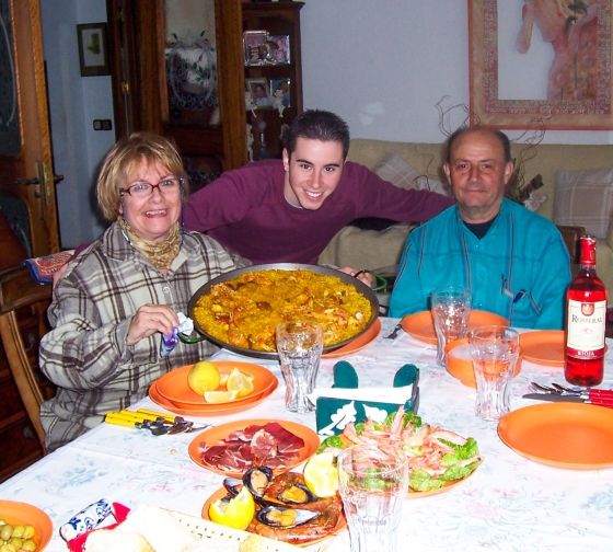 A student enjoying paella with his host family