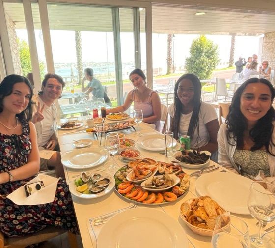 students share meal together lisbon study abroad