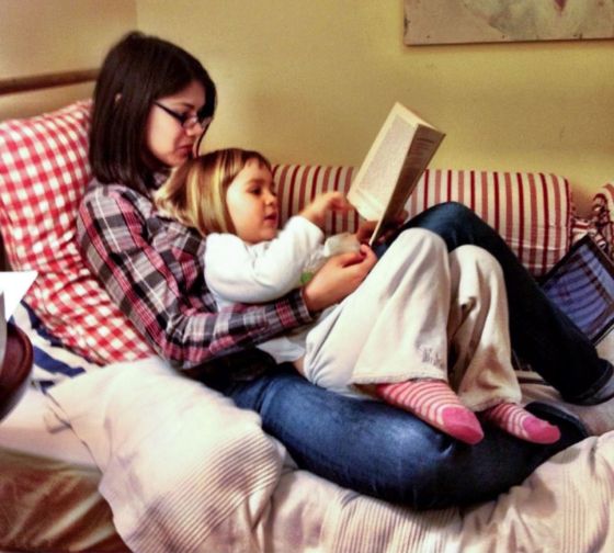 Madrid student reading to host family toddler
