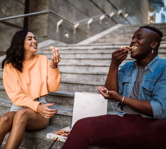 Milan students eating pizza on a staircase