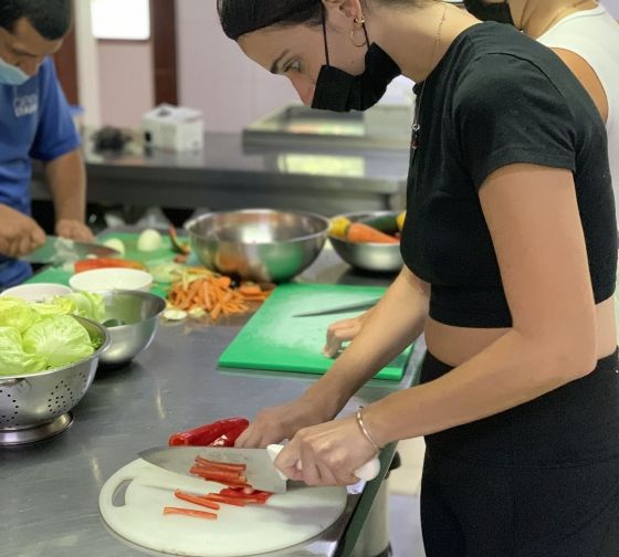 student cutting pepper abroad monteverde