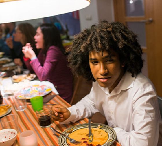 Student enjoying dinner with their host family.