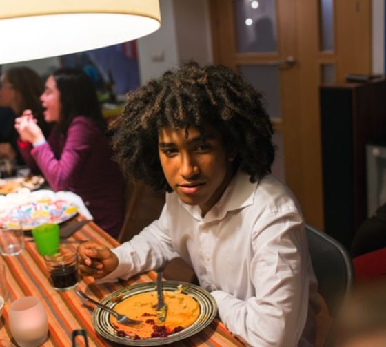 ciee-seville Student enjoying dinner with their host family