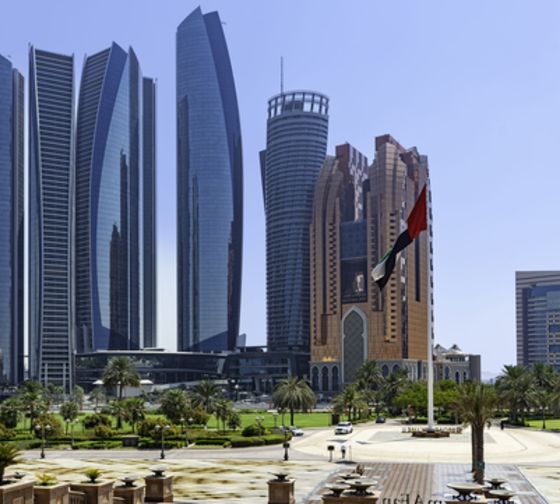 abu dhabi skyline buildings flag