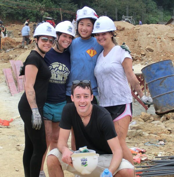 Interns wearing hardhats at a community development site