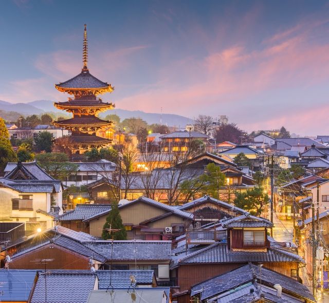 sunset in kyoto with buildings lights