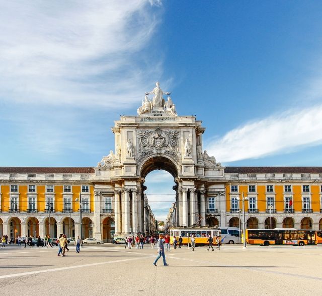 lisbon plaza with archway and yellow building