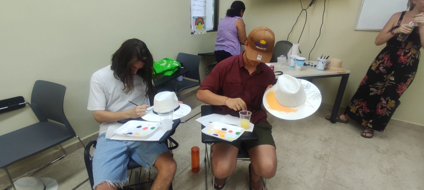 Students painting a hat