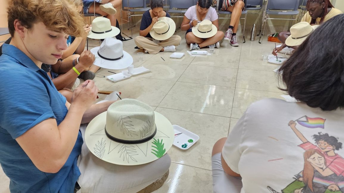 Student painting a hat