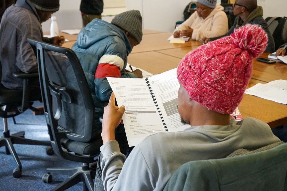 Community participants reading through their workbooks 