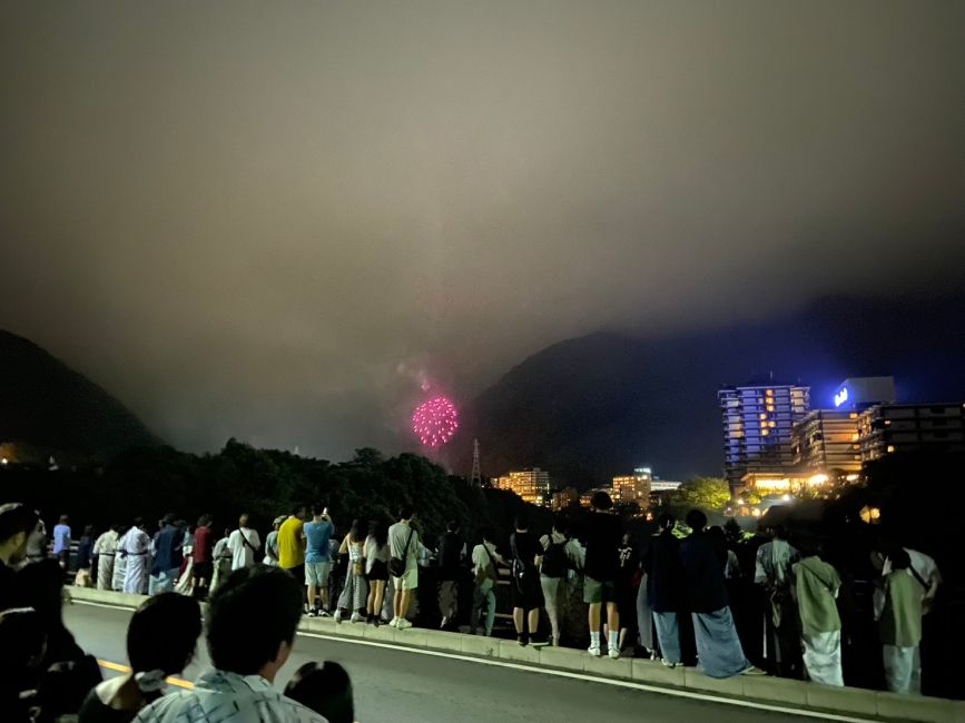 Students watching fireworks along the bridge