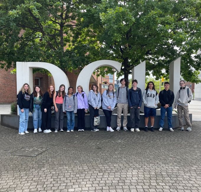 The GE cohort standing in front of a Dublin City University sign while on a quick trip to DCU's business campus.