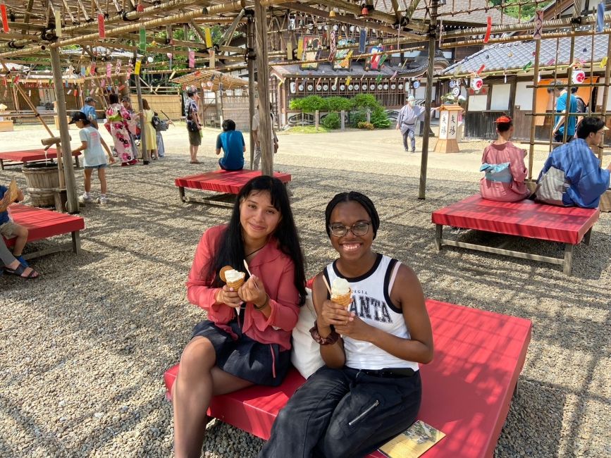 Students enjoying the breeze under the wind chimes