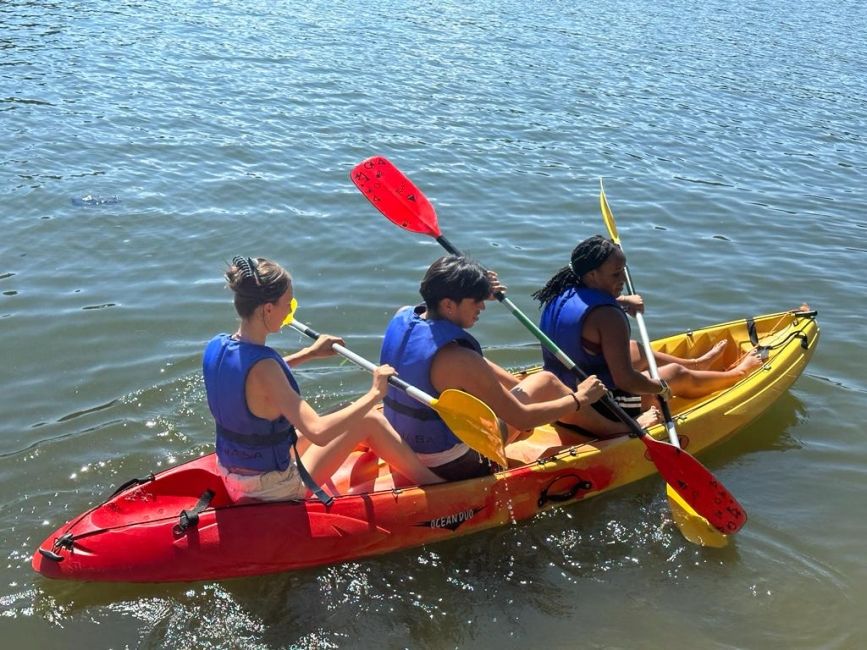 Students in a kayak on the water