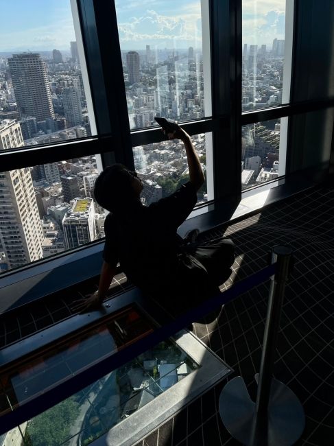 Student taking a selfie on the glass floor in Tokyo Tower