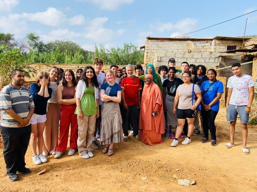 A large group of CIEE students standing for a picture in a rural area in Morocco